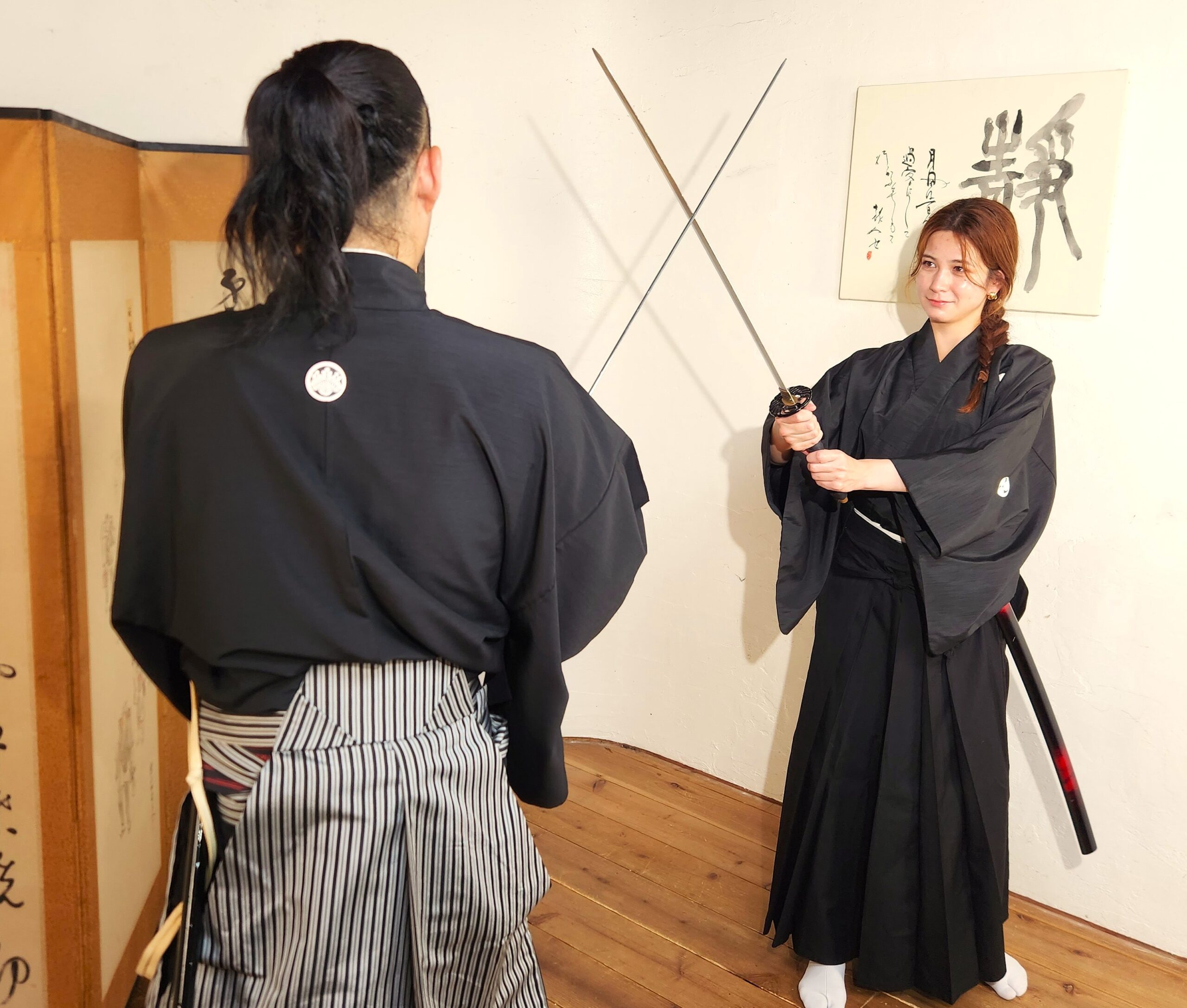 Participants learning Samurai sword movements during a Bushido workshop